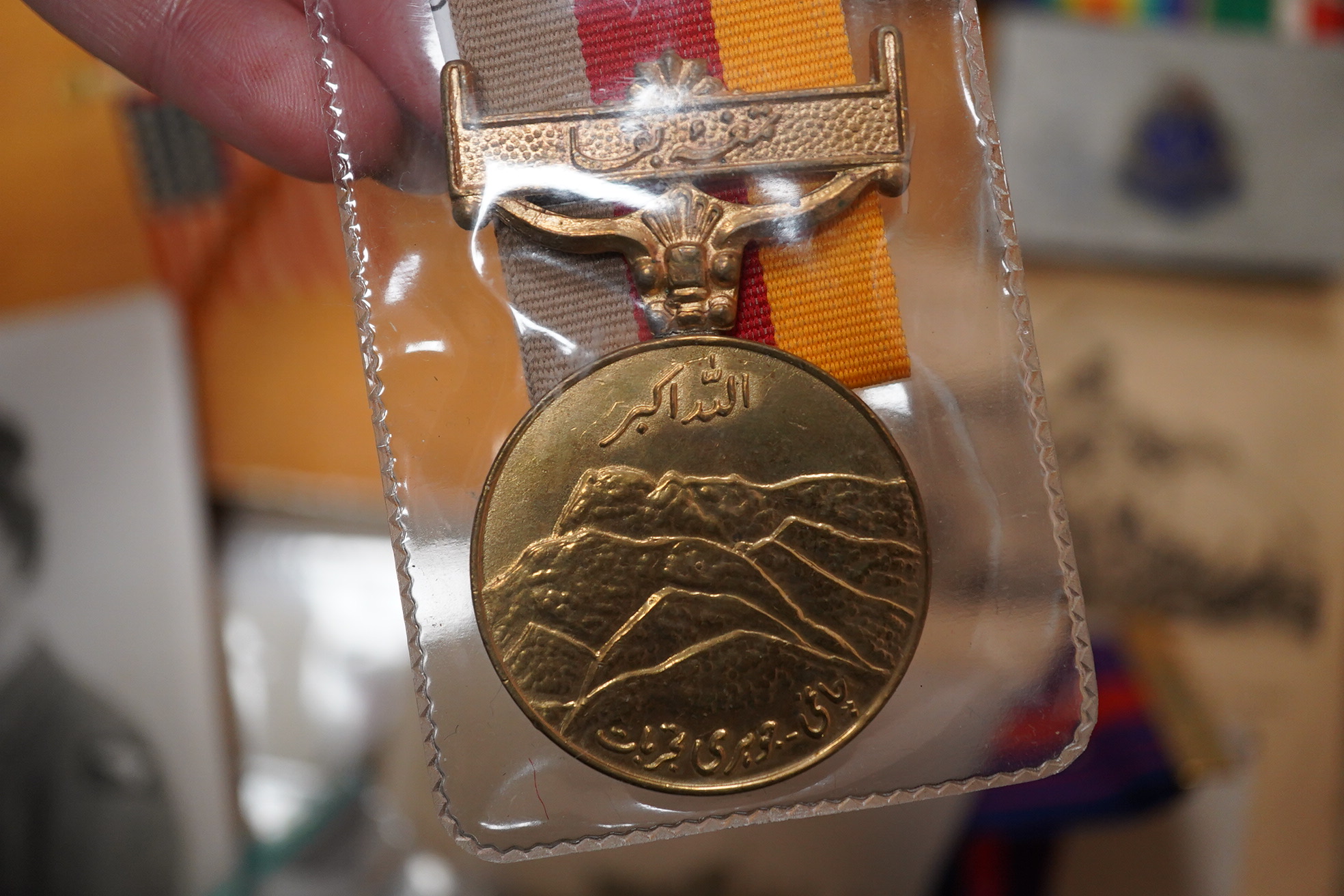 A quantity of various military ephemera to include a Coldstream guards matchbox holder, a death plaque and another 19th century glass plaque, buttons, badges, National Registration Identity Card, various photos and lette